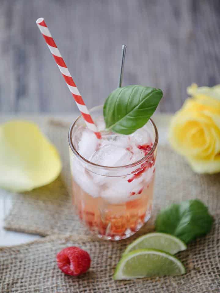 Apple juice cocktail with gin and raspberries.